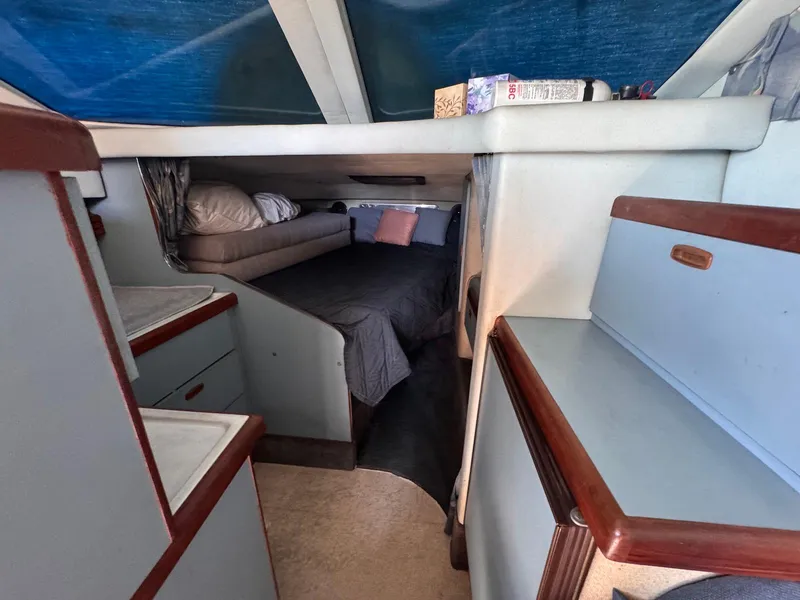 Slide: The Image of Interior cabin of 1988 Sea Ray 265 Sedan Bridge with bed and storage. - 14