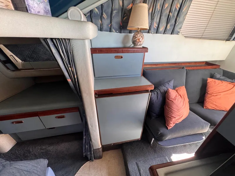 Slide: The Image of Interior of 1988 Sea Ray 265 Sedan Bridge with cozy seating and storage. - 23