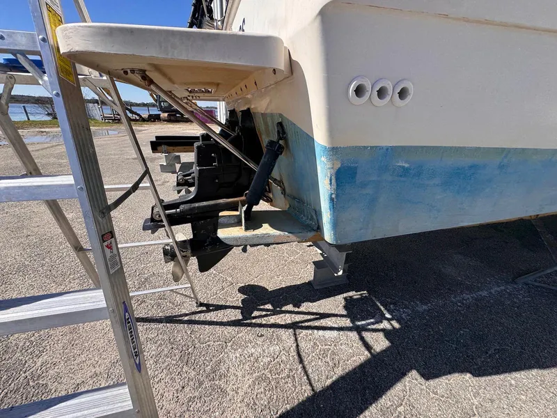 Slide: The Image of 1988 Sea Ray 265 Sedan Bridge boat stern with ladder, outboard motor, and blue hull. - 3