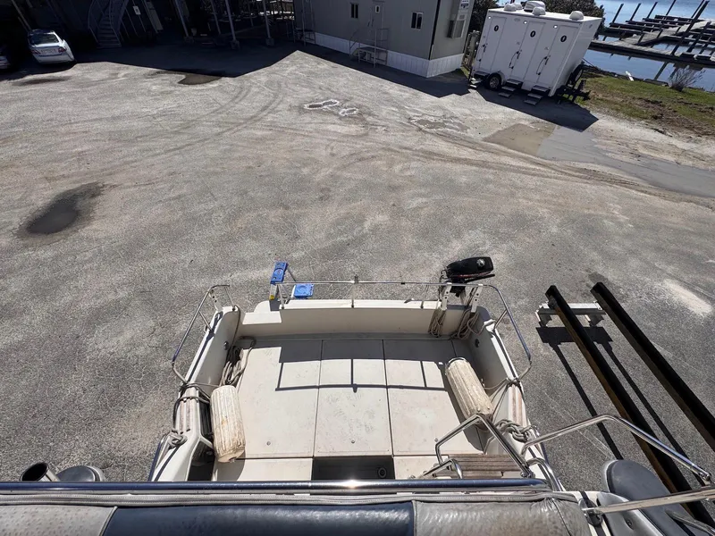 Slide: The Image of 1988 Sea Ray 265 Sedan Bridge boat on dry land, viewed from above. - 31