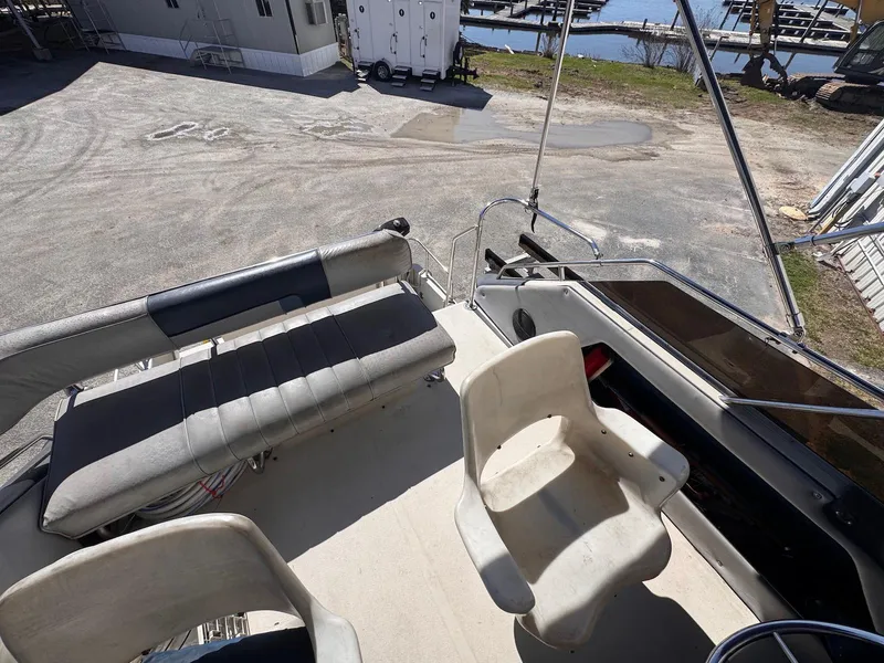 Slide: The Image of 1988 Sea Ray 265 Sedan Bridge boat interior with seating and helm area. - 33