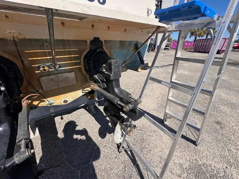 Slide: The Image of 1988 Sea Ray 265 Sedan Bridge boat maintenance with ladder and tools. - 4