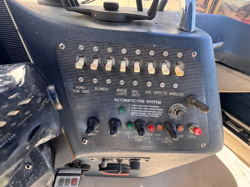 Slide: The Image of Control panel of a 1988 Sea Ray 265 Sedan Bridge boat with switches and indicators. - 40