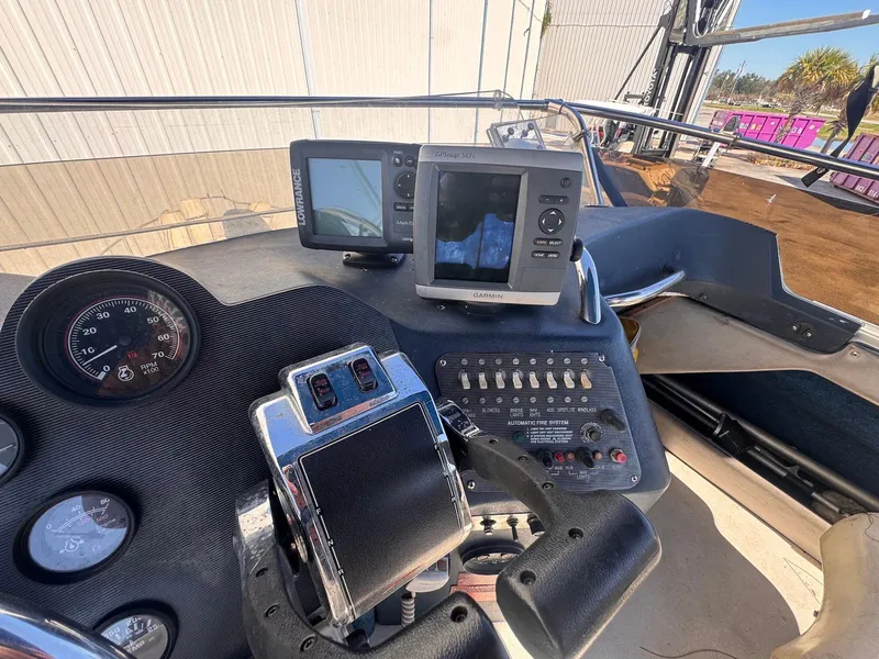 Slide: The Image of 1988 Sea Ray 265 Sedan Bridge dashboard with navigation equipment and controls. - 44