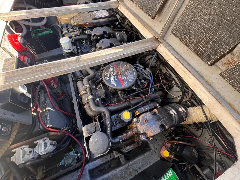Slide: The Image of Engine compartment of a 1988 Sea Ray 265 Sedan Bridge boat, showing detailed mechanical components. - 47