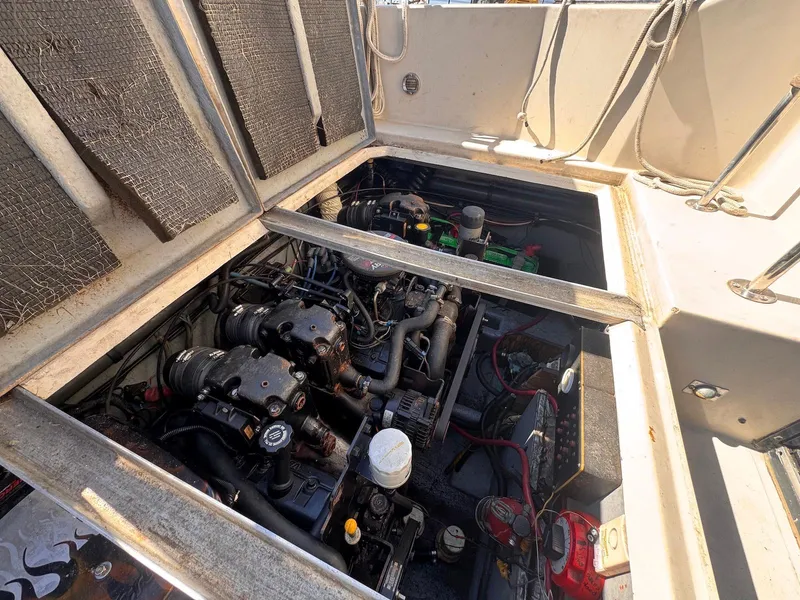 Slide: The Image of Engine compartment of 1988 Sea Ray 265 Sedan Bridge boat, showing mechanical components. - 48