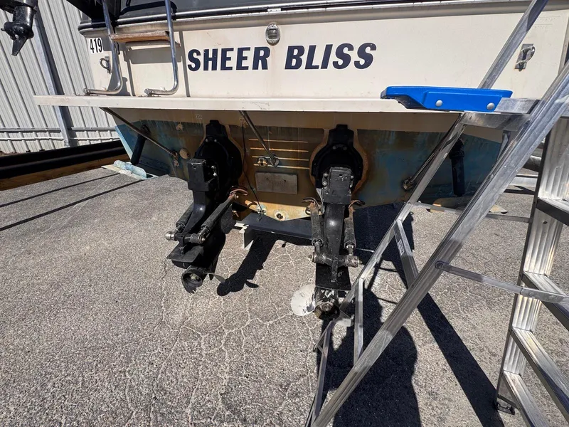 Slide: The Image of 1988 Sea Ray 265 Sedan Bridge boat stern with dual outboard motors on display. - 6