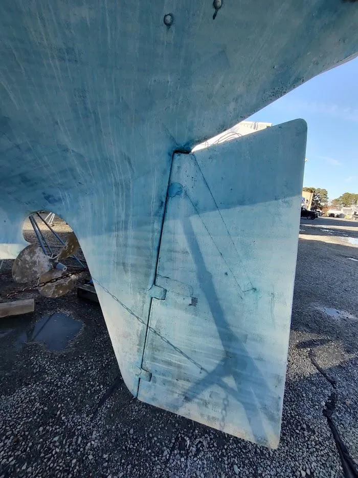 Slide: The Image of Close-up of a 1977 Hallberg-Rassy 41 sailboat rudder and hull, showing blue paint and shadow. - 10