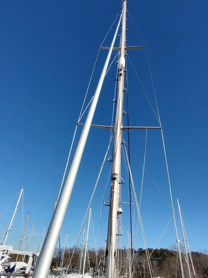 Slide: The Image of Tall mast of a 1977 Hallberg-Rassy 41 sailboat against a clear blue sky. - 14