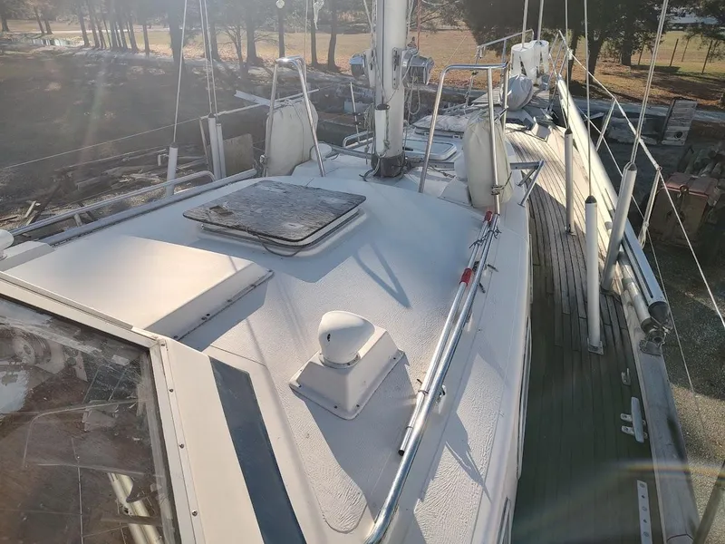Slide: The Image of 1977 Hallberg-Rassy 41 sailboat deck with mast and rigging in a sunny setting. - 17