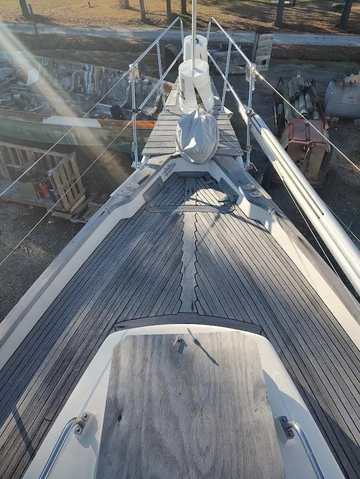 Slide: The Image of 1977 Hallberg-Rassy 41 sailboat deck with wooden finish and railing. - 19