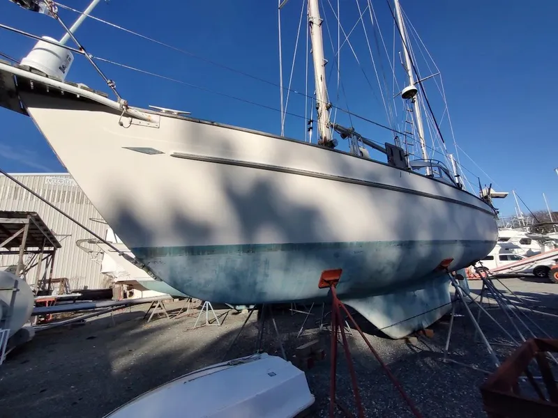 Slide: The Image of 1977 Hallberg-Rassy 41 sailboat on dry dock under clear blue sky. - 2