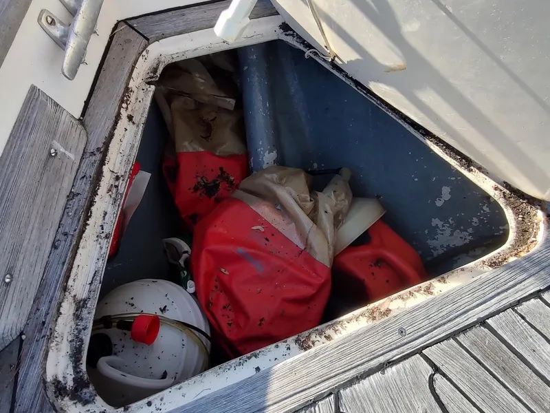 Slide: The Image of Open hatch on 1977 Hallberg-Rassy 41 sailboat, showing storage with red gear and helmet. - 24