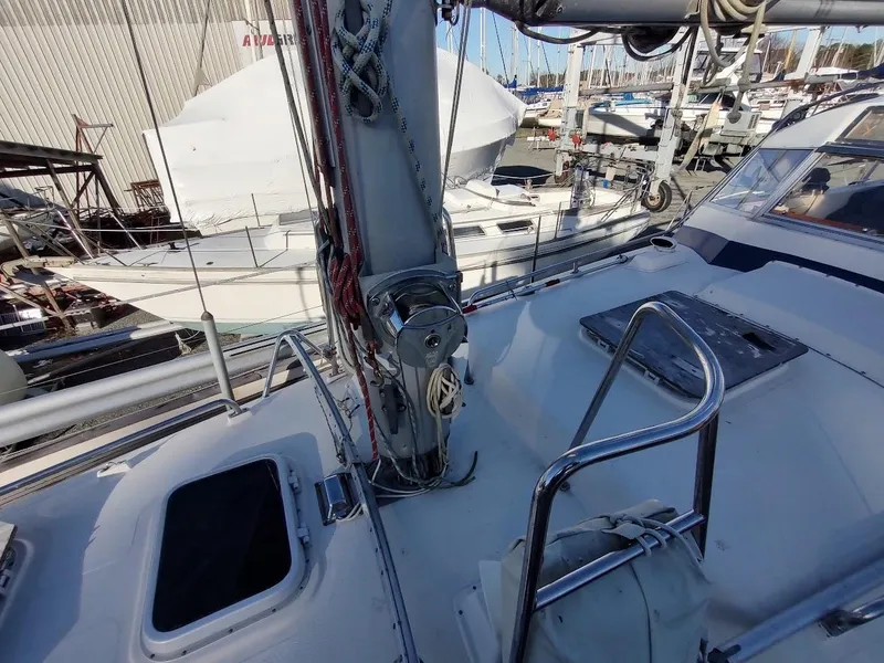 Slide: The Image of 1977 Hallberg-Rassy 41 sailboat deck with mast and rigging in a marina setting. - 25