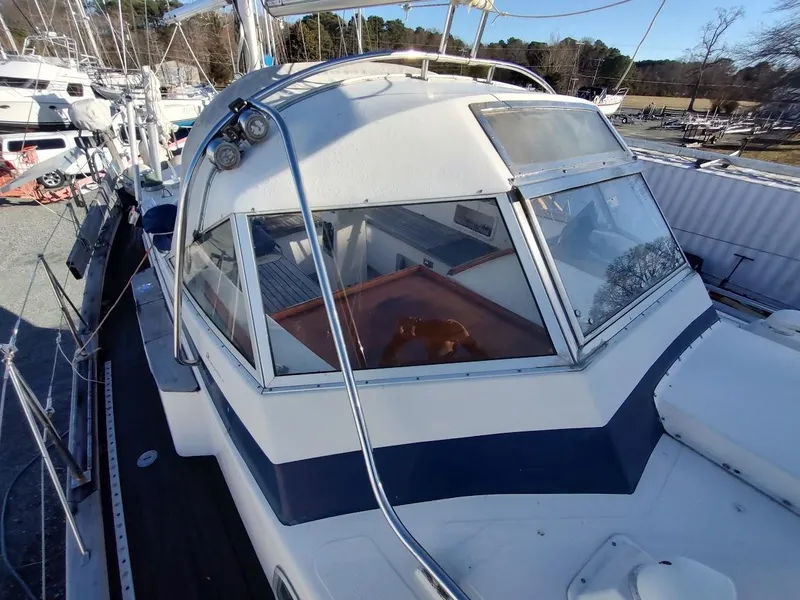 Slide: The Image of 1977 Hallberg-Rassy 41 sailboat with cockpit and deck view in a marina setting. - 28