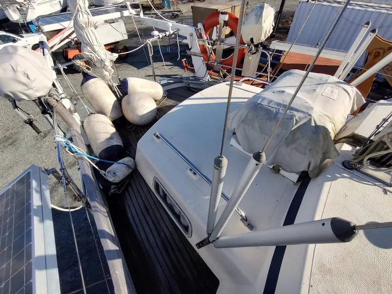 Slide: The Image of 1977 Hallberg-Rassy 41 sailboat deck with fenders and solar panel. - 31