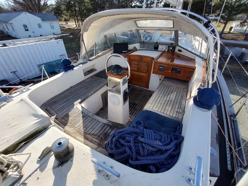 Slide: The Image of 1977 Hallberg-Rassy 41 sailboat cockpit with wooden accents and nautical equipment. - 33