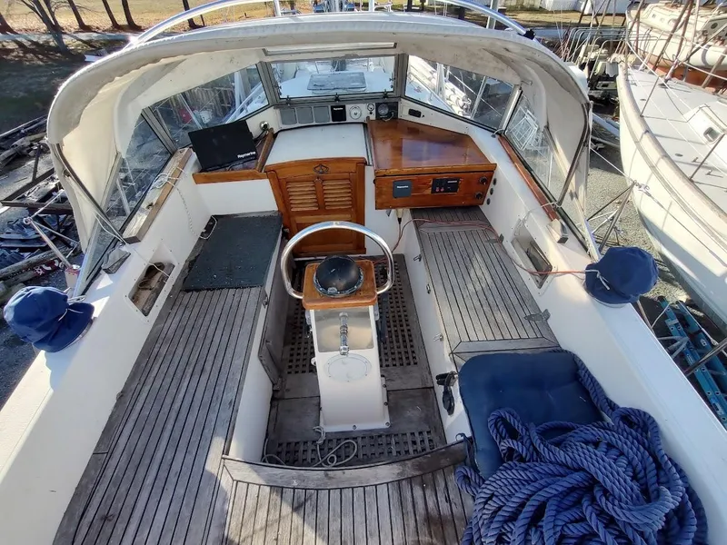Slide: The Image of 1977 Hallberg-Rassy 41 yacht cockpit with wooden steering wheel and navigation equipment. - 40