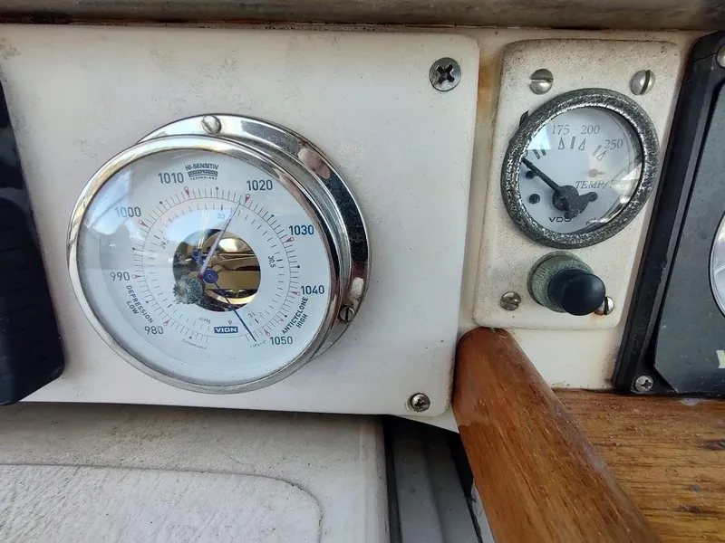 Slide: The Image of Barometer and temperature gauge on a 1977 Hallberg-Rassy 41 yacht dashboard. - 45