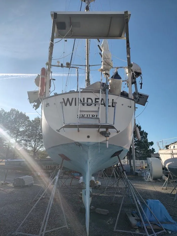 Slide: The Image of 1977 Hallberg-Rassy 41 sailboat on land, rear view, with clear blue sky. - 7