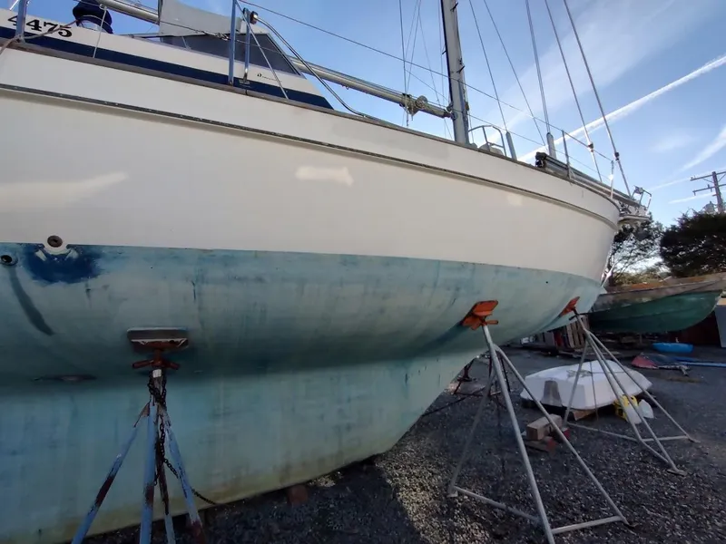 Slide: The Image of 1977 Hallberg-Rassy 41 sailboat on stands, undergoing maintenance in a boatyard. - 9