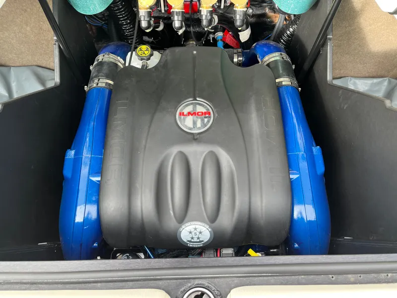 Slide: The Image of 2022 MasterCraft X24 Ilmor engine with blue accents in boat compartment. - 14