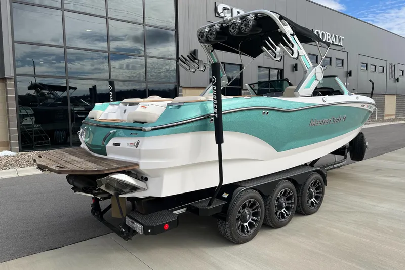 Slide: The Image of 2022 MasterCraft X24 boat on a trailer, parked outside a dealership. - 3