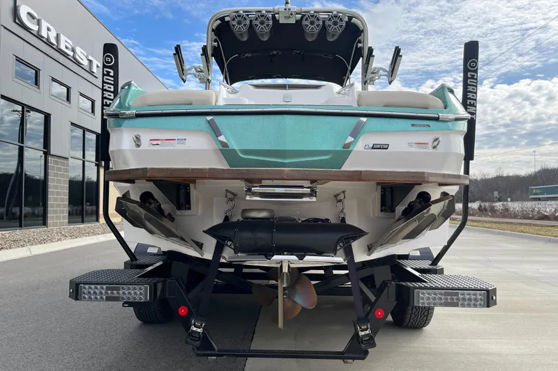 Slide: The Image of 2022 MasterCraft X24 boat on trailer, rear view, parked outside dealership. - 7