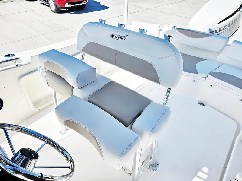 Slide: The Image of 2025 Bulls Bay 230 CC boat interior with cushioned seating and steering wheel. - 11