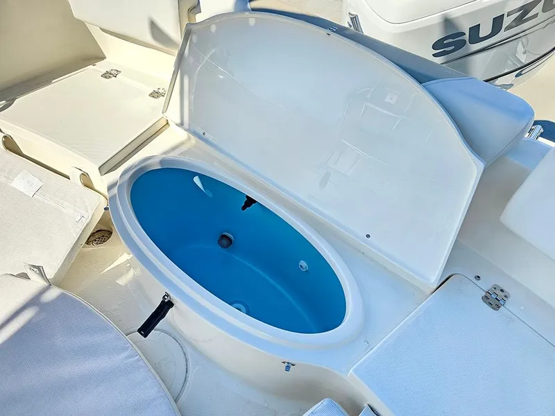 Slide: The Image of 2025 Bulls Bay 230 CC boat with open storage compartment and Suzuki engine. - 14