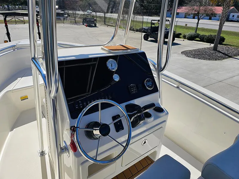 Slide: The Image of 2025 Bulls Bay 230 CC boat console with steering wheel and gauges. - 17