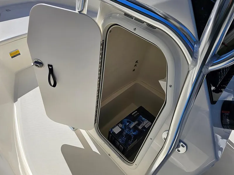 Slide: The Image of 2025 Bulls Bay 230 CC boat storage compartment with open door, showcasing interior space. - 20