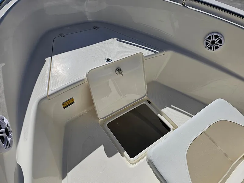 Slide: The Image of 2025 Bulls Bay 230 CC boat interior with open storage compartment and seating. - 22
