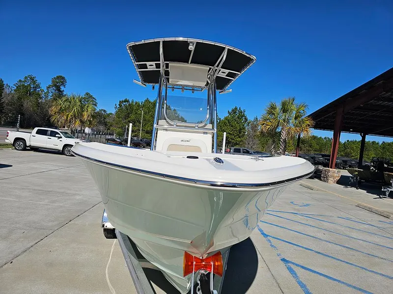 Slide: The Image of 2025 Bulls Bay 230 CC boat on trailer, parked outdoors under clear blue sky. - 4