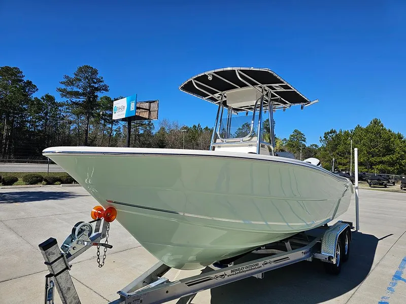 Slide: The Image of 2025 Bulls Bay 230 CC boat on trailer, parked outdoors under clear blue sky. - 5