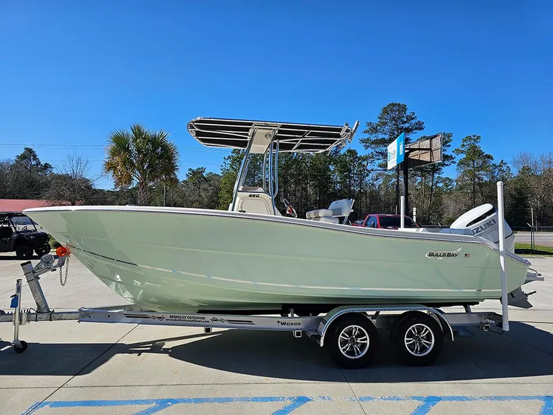 Slide: The Image of 2025 Bulls Bay 230 CC boat on trailer, parked outdoors. - 6