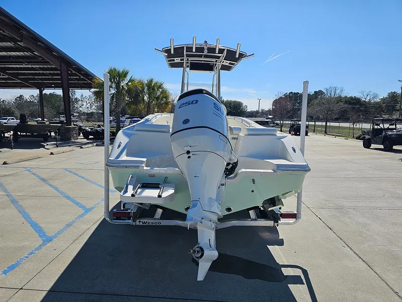 Slide: The Image of 2025 Bulls Bay 230 CC boat with powerful outboard motor, parked outdoors. - 8