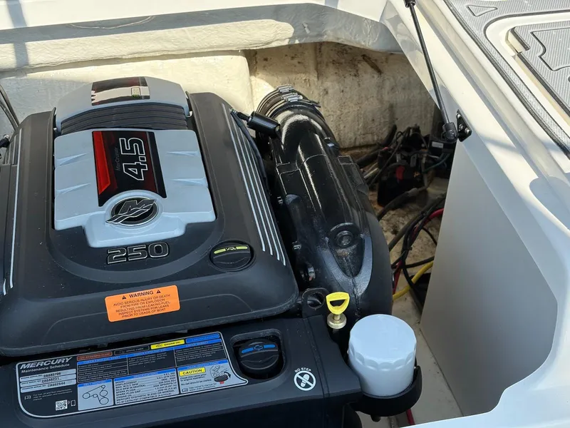 Slide: The Image of Engine compartment of a 2021 Chaparral 23 SSi boat, featuring a Mercury 4.5L 250 engine. - 10