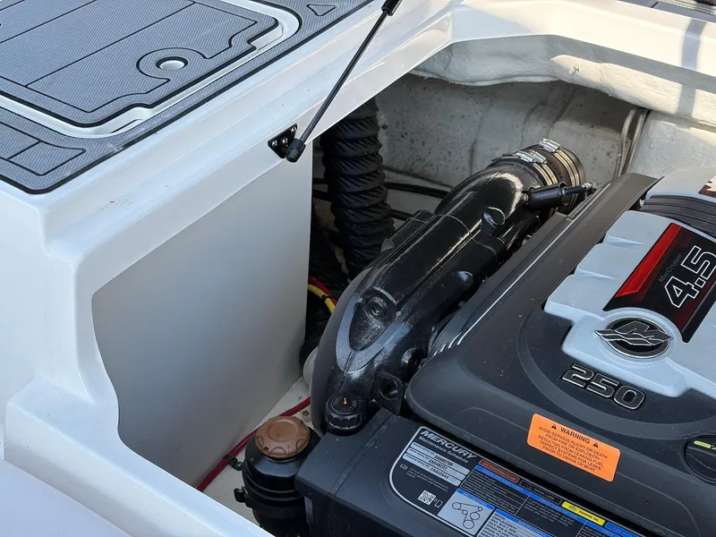 Slide: The Image of Engine compartment of a 2021 Chaparral 23 SSi boat, featuring a 4.5L Mercury engine. - 13