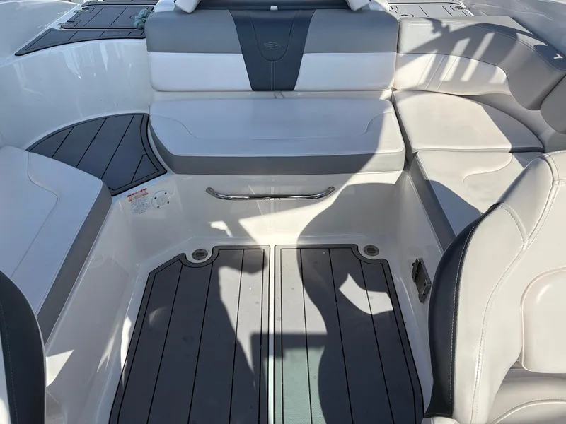 Slide: The Image of 2021 Chaparral 23 SSi boat interior with white and gray seating and flooring. - 3