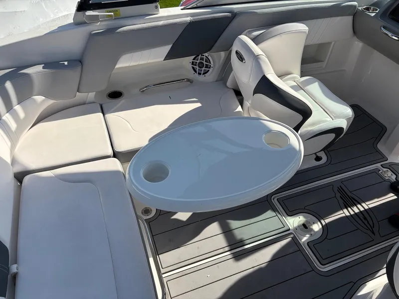 Slide: The Image of 2021 Chaparral 23 SSi boat interior with seating and table setup. - 6