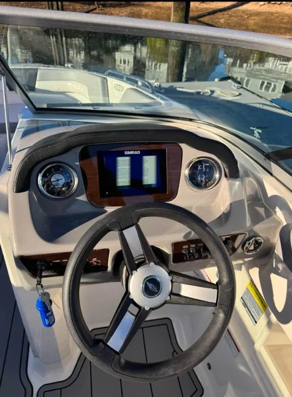Slide: The Image of 2021 Chaparral 23 SSi boat dashboard with steering wheel and digital display. - 8