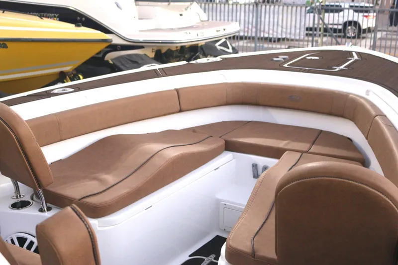 Slide: The Image of 2022 Sea Hunt Ultra 305 SE boat interior with brown seating and white accents. - 13