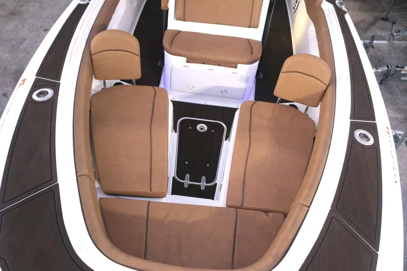 Slide: The Image of 2022 Sea Hunt Ultra 305 SE boat interior with brown cushioned seating and storage compartments. - 14
