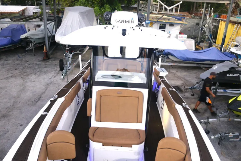 Slide: The Image of 2022 Sea Hunt Ultra 305 SE boat with Garmin equipment, docked in a marina. - 15