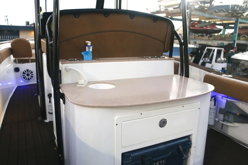 Slide: The Image of 2022 Sea Hunt Ultra 305 SE boat interior with countertop and seating area. - 18