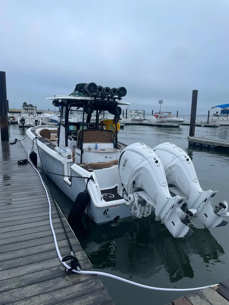 Slide: The Image of 2022 Sea Hunt Ultra 305 SE boat docked with dual engines. - 19
