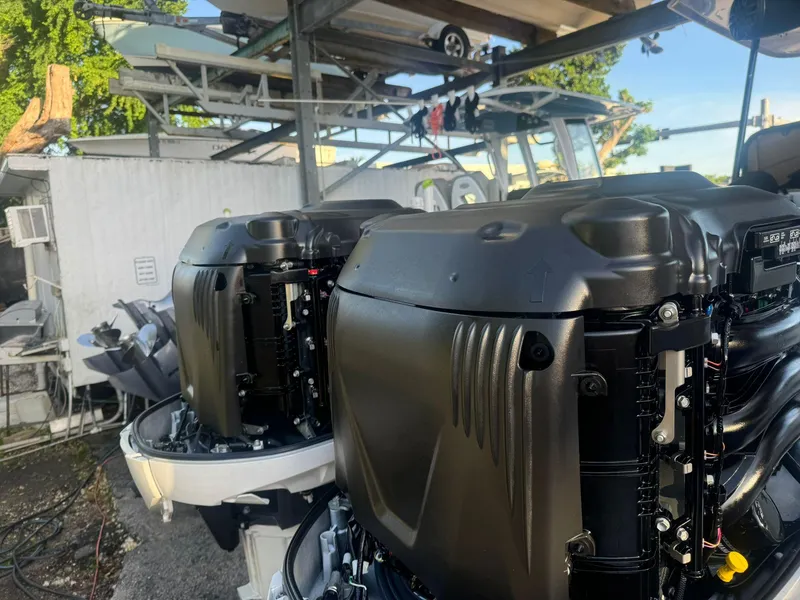 Slide: The Image of 2022 Sea Hunt Ultra 305 SE boat engines in a marina setting. - 20