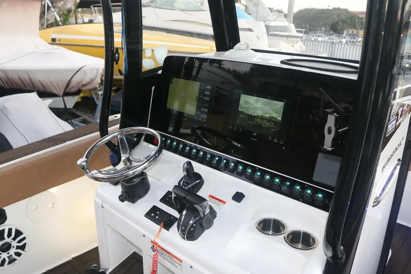Slide: The Image of 2022 Sea Hunt Ultra 305 SE boat dashboard with modern controls and navigation screens. - 8