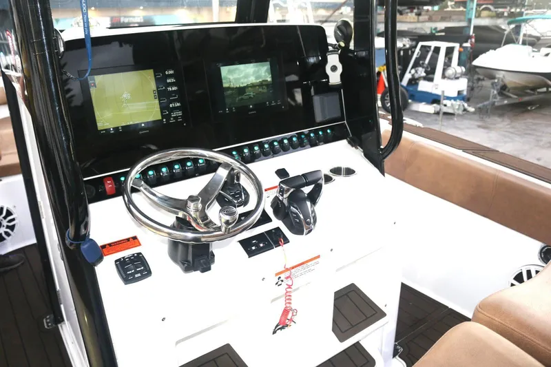 Slide: The Image of 2022 Sea Hunt Ultra 305 SE boat dashboard with modern controls and navigation screens. - 9